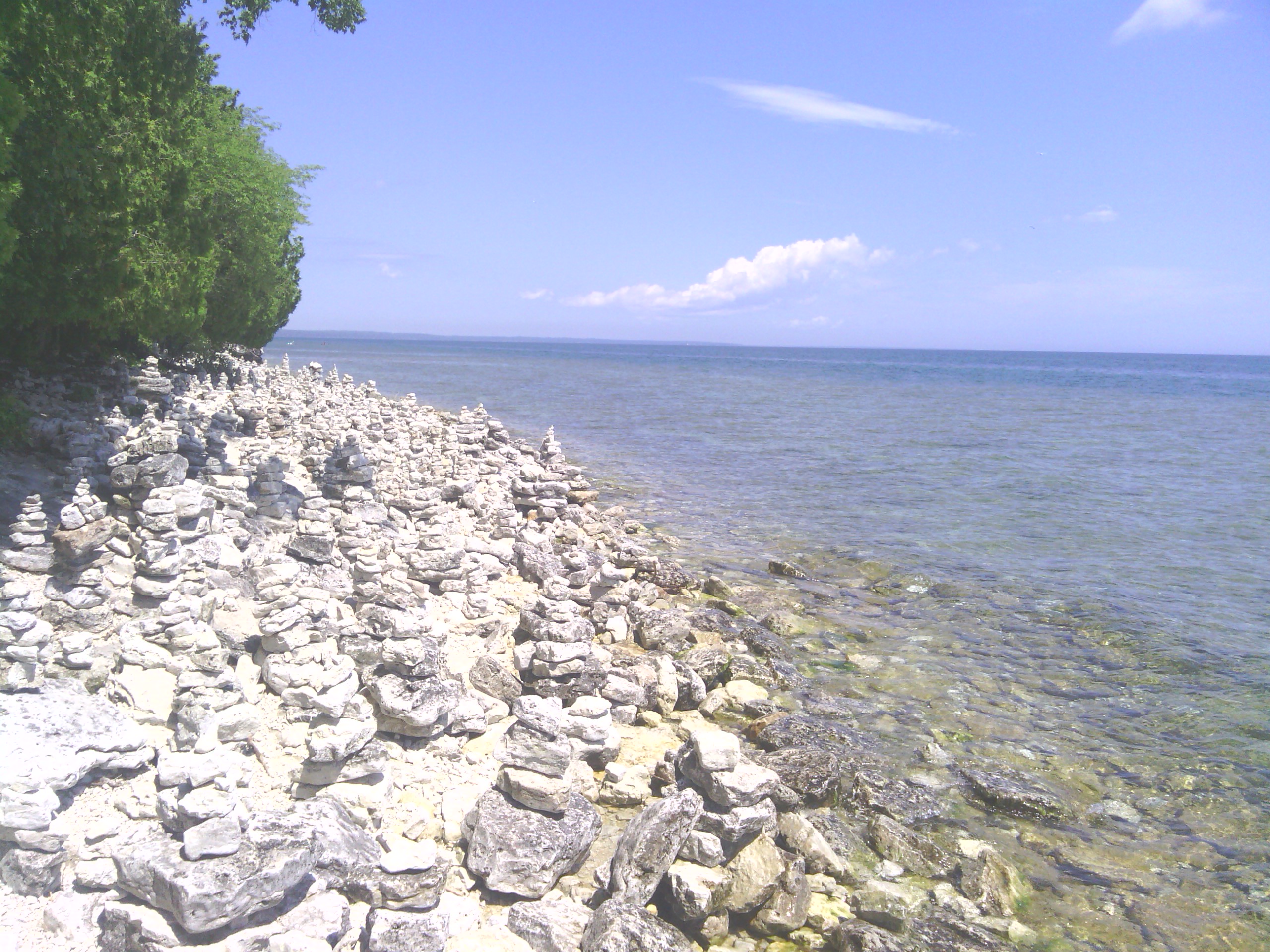 Background of lakeshore with stacked white rocks