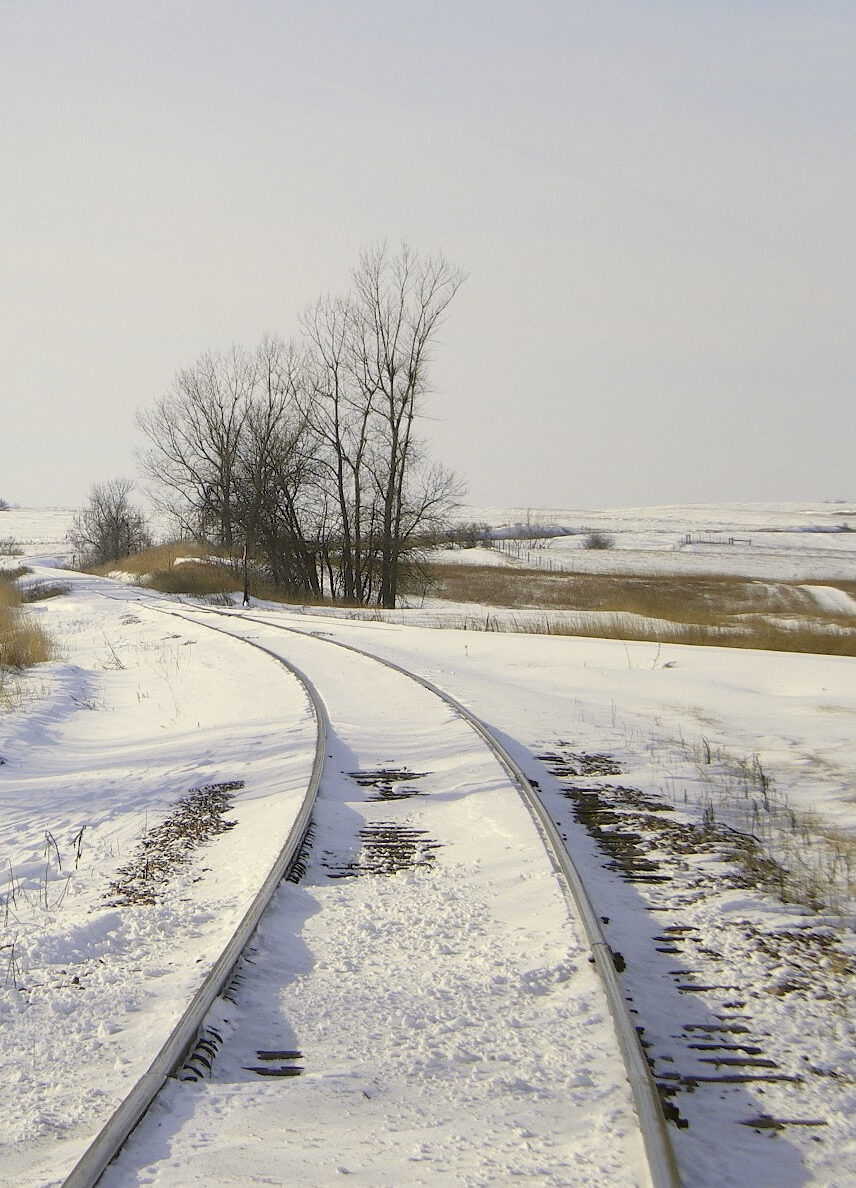 Background of barren winter scene with snow and railroad tracks